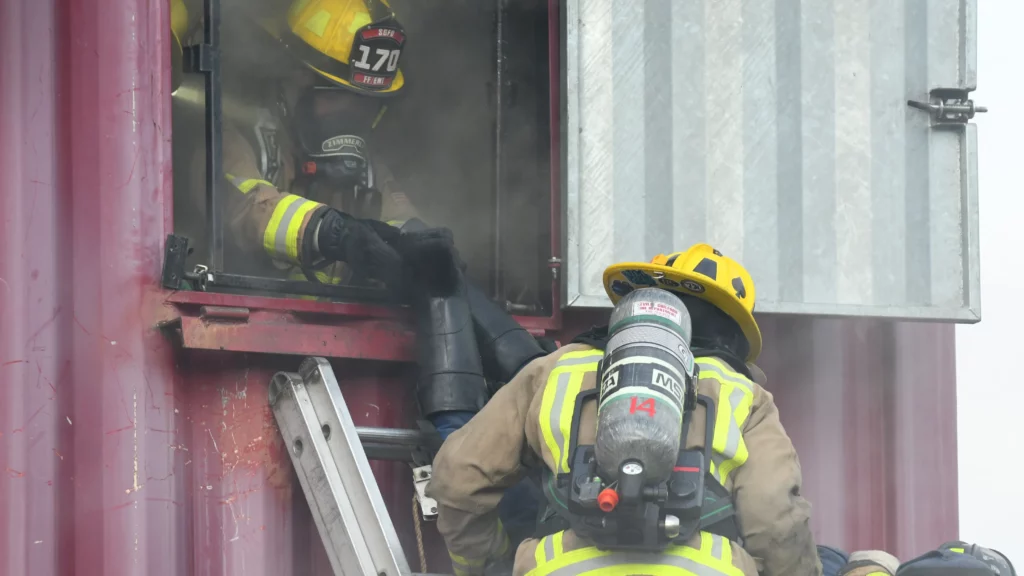 firefighters training in a burn tower attempting to mitigate the risks of firefighting
